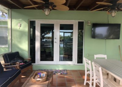 House porch with impact window with white frames